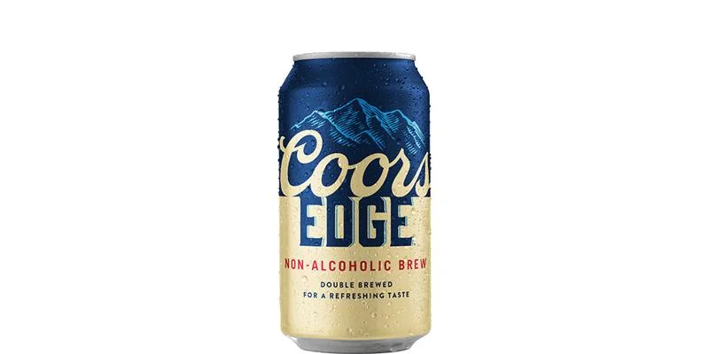 Refreshing Coors Edge non-alcoholic beer featuring a golden lager style with balanced hop bitterness and a smooth finish against a plain background.