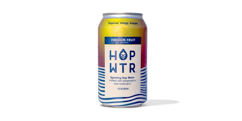 HOP WTR Passionfruit, a clear, carbonated drink with natural passionfruit flavor against a plain background.