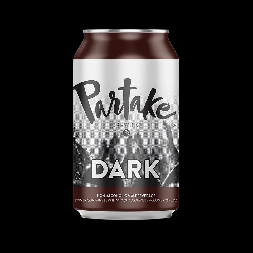 Dark alcohol-free beer by Partake Brewing showcasing deep mahogany color and smooth medium body in an alcohol-free lager